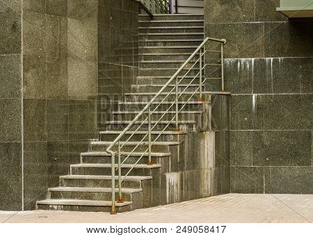 Steps And Walls Made Of Marble Slabs With Metal Handle Made Of Pipes