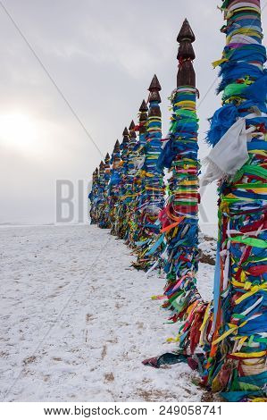 Wooden Ritual Pillars With Colorful Ribbons On Cape Burkhan, Lake Baikal, Olkhon Island, Siberia, Ru