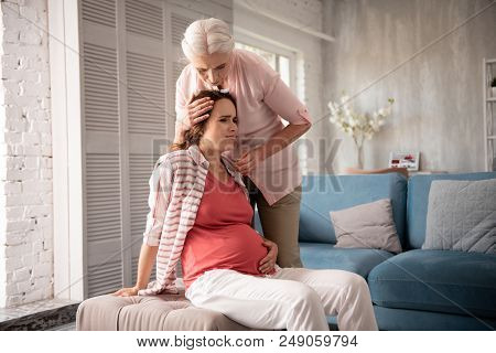 Feeling Dizzy. Caring Mother Feeling Extremely Worried While Pregnant Daughter Feeling Dizzy