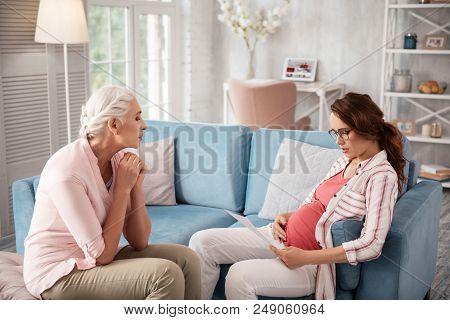 Info About Childbirth. Beautiful Expecting Woman Wearing Nice Black Glasses Reading Information Abou