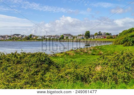 Lough Atalia Bay With Houses In Background And Cloud Reflection