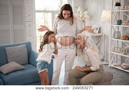 Having Fun. Stylish Expecting Woman Feeling Unbelievably Happy And Entertained Having Fun With Her F