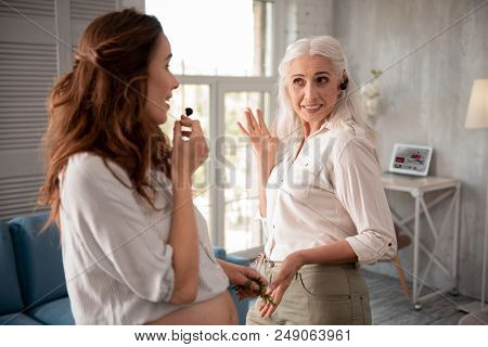 Fun With Daughter. Funny Smiling Woman Putting Sweet Cherry On Her Ear Having Fun With Daughter
