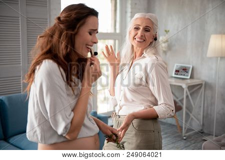 Eating Cherry. Pregnant Smiling Woman Having Lots Of Fun With Her Mother While Eating Sweet Cherry