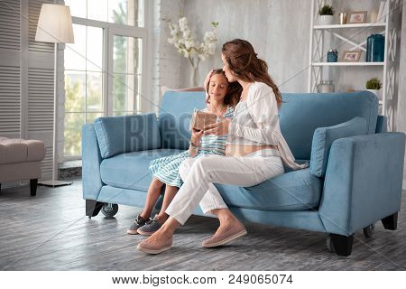 Kissing Girl. Expecting Woman Holding Little Nice Present Box Kissing Her Little Girl While Sitting 