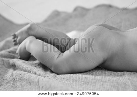 Naked Newborn Baby Lying On His Tummy. Little Boy On Grey Background. Advertising Prevention In Medi
