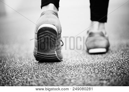 Woman walking alone on a road