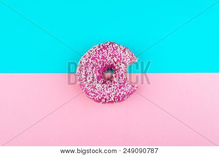 One Pink Isolated Donut On A Mint And Pink Background. Fashion Minimal.