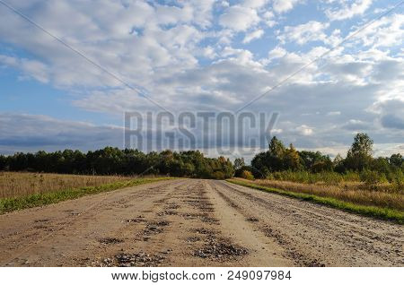 Bad Country Macadam Road With Many Pot-holes, Autumn Day