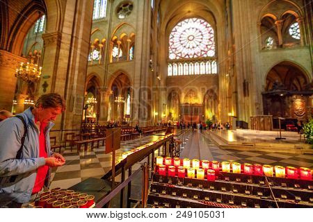 Paris, France - July 1, 2017: People Lighting The Candles In Central Nave Altar Of Notre Dame Of Par
