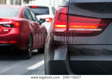 Blurred Busy Road, Rear View Of A Car, Displaying Stop Ligths