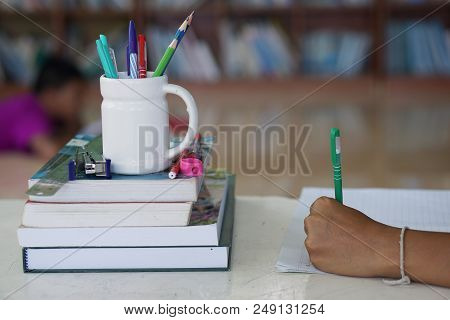 Books Pencil And Stationery On The Desk In School Libraries.