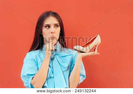 Girl Holding A High Heel Shoe Thinking About Wearing It