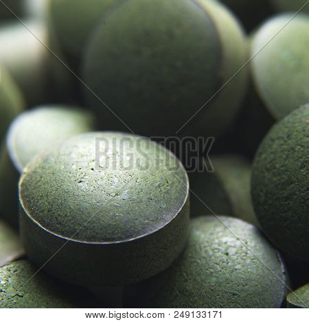 Blue Green Algae. Close Up Of Natural Organic Spirulina Tablets With Focus At The Foreground And Blu