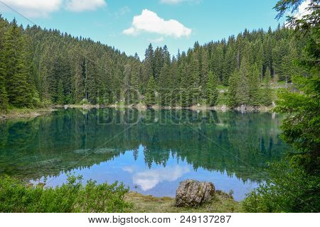 Lake Carezza With Reflection Of Mountains In The Dolomites