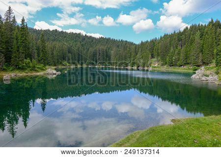 Lake Carezza With Reflection Of Mountains In The Dolomites