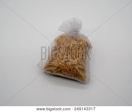 Rice Bran In See Through Net Fabric Bag Isolated On White