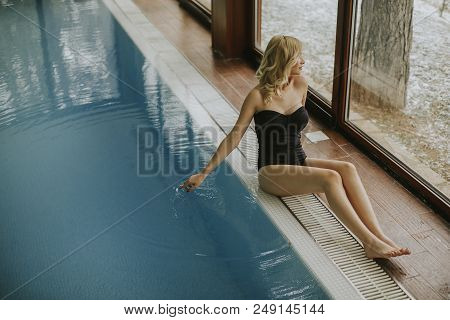 Pretty Young Woman Relaing By The Swimming Pool