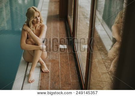 Pretty Young Woman Relaing By The Swimming Pool