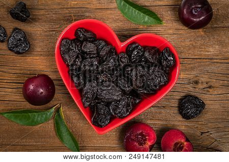 Dried Plums Pitted Prunes In Heart Shaped Bowl. Selective Focus.