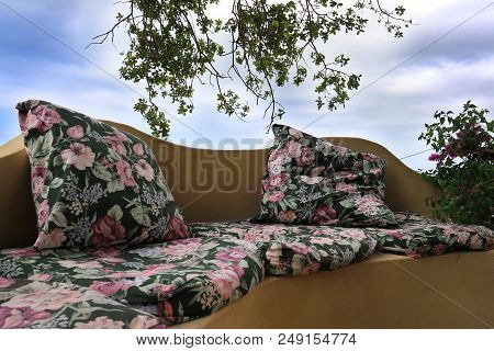 A Seating Area Made Comfortable With Cushions In The Garden.