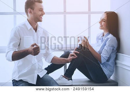 Beautiful Young Business Couple In Classic Shirts Holding White Cups Of Coffee. Handsome Man And His