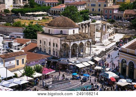 ATHENS GREECE, JUN 11 2016:: Tzistarakis Mosque and metro station in Monastiraki square in the old town of Athens, Greece on Jun 11, 2016.
