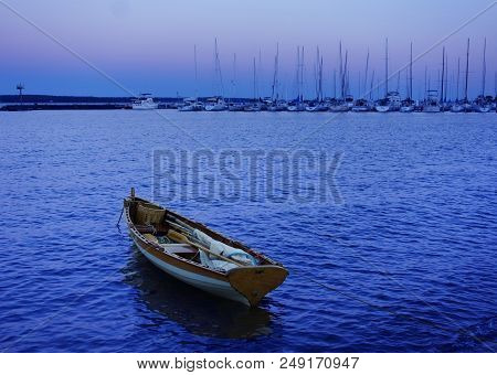 Small Sailboat At The Marina At Dusk In Bayfield Wisconsin With The Apostle Islands In The Distance