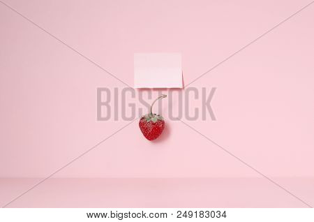 Red Strawberry On The Pink Table And One Sticker