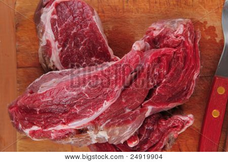 savory: uncooked raw bloody beef meat steak before cooking on wood