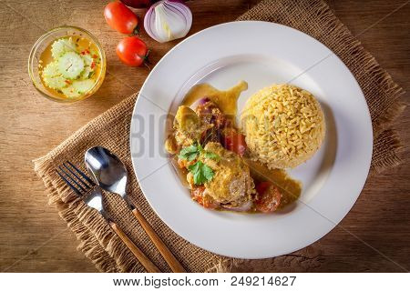 Curry Chicken And Rice On Wooden Table