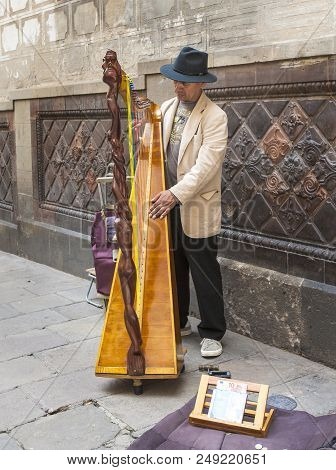Barcelona, Spain 9 June 2018:  Unknown Street Harpist On One Of The Streets In Old Downtown.