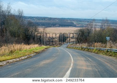 The Motorway Descends From A High Hill. Autumn View