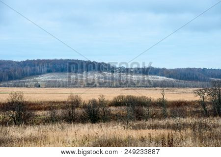 Autumn Landscape. The Forest Has Already Discarded The Foliage And The First Snow Has Already Fallen
