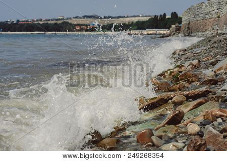 Tidal Bore. Waves Are Beating Against Stones.