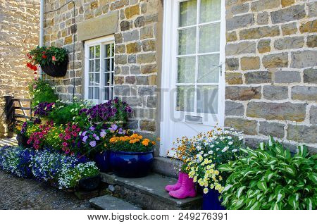 Cottage Front With Lots Of Container Plants