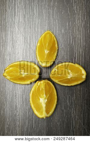 Orange Fruit. Four Orange Slice And Pieces Isolate On Black Wood.