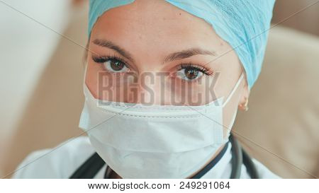Close-up Of Young Female Doctor With A Mask On Face.