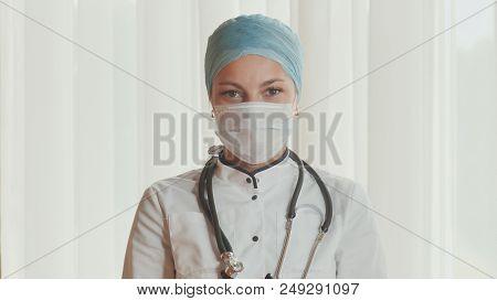 Portrait Of A Young Female Doctor In A Mask