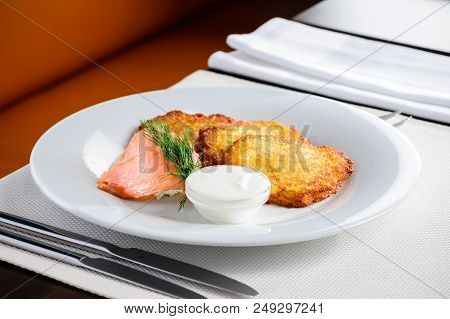 Traditional Belarus Potato Pancakes Draniki With Sour Cream In A Plate At A Cafe