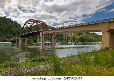 Sauvie Island Bridge With Wildflowers Over Floating Homes Along Multnomah Channel In Portland Oregon