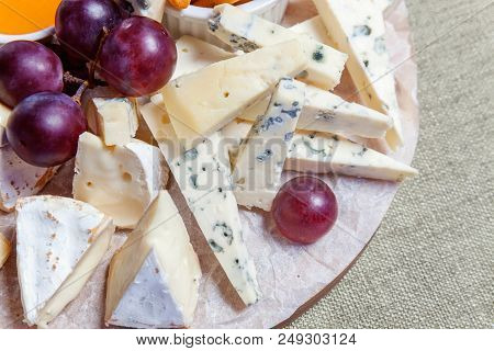 Board With Different Types Of Cheese: Dor Blu, Chedar, Parmesan, Brie, Honey Sauce, Finger Bread And