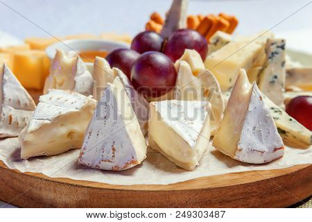 Board With Different Types Of Cheese: Dor Blu, Chedar, Parmesan, Brie, Honey Sauce, Finger Bread And