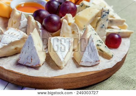 Board With Different Types Of Cheese: Dor Blu, Chedar, Parmesan, Brie, Honey Sauce, Finger Bread And