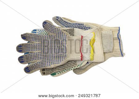 Stack Of Knitted Working Gloves With Colorful Rubber Dots, Neatly Arranged On The White Background. 