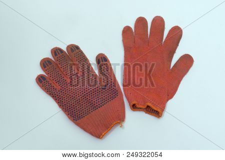 Work Gloves Of Orange-red Cotton. One Is Turned Inside Out. Pair With Stretchable Cuff With Bright O