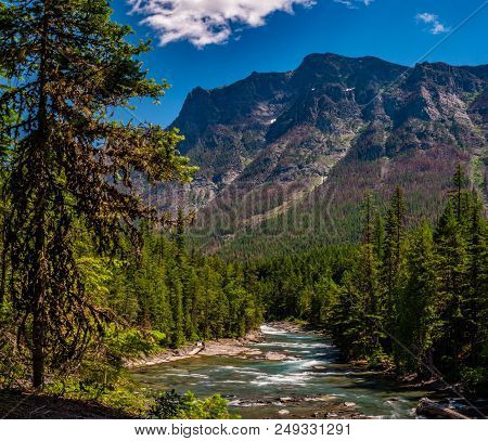 A View From A Rustic Rest Bench Alongjohns Lake Loop Next To Mcdonald Creek, In Gnp