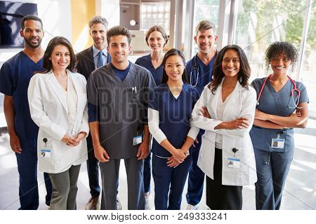Team of healthcare workers at a hospital smiling to camera