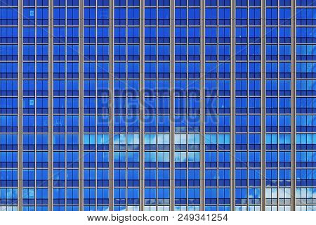 Multi-storey Office Building Day With Worker Working Hard. Day At Office. Clouds And Sky Reflecting 