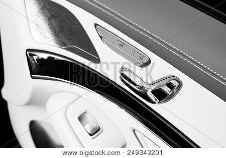 Door Handle With Power Seat Contol Buttons Of A Luxury Passenger Car. White Leather Interior Of The 